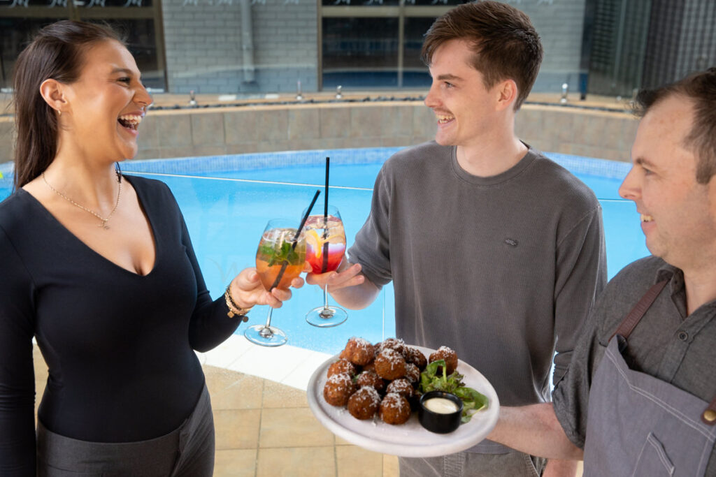 Guests laughing at Poolside event